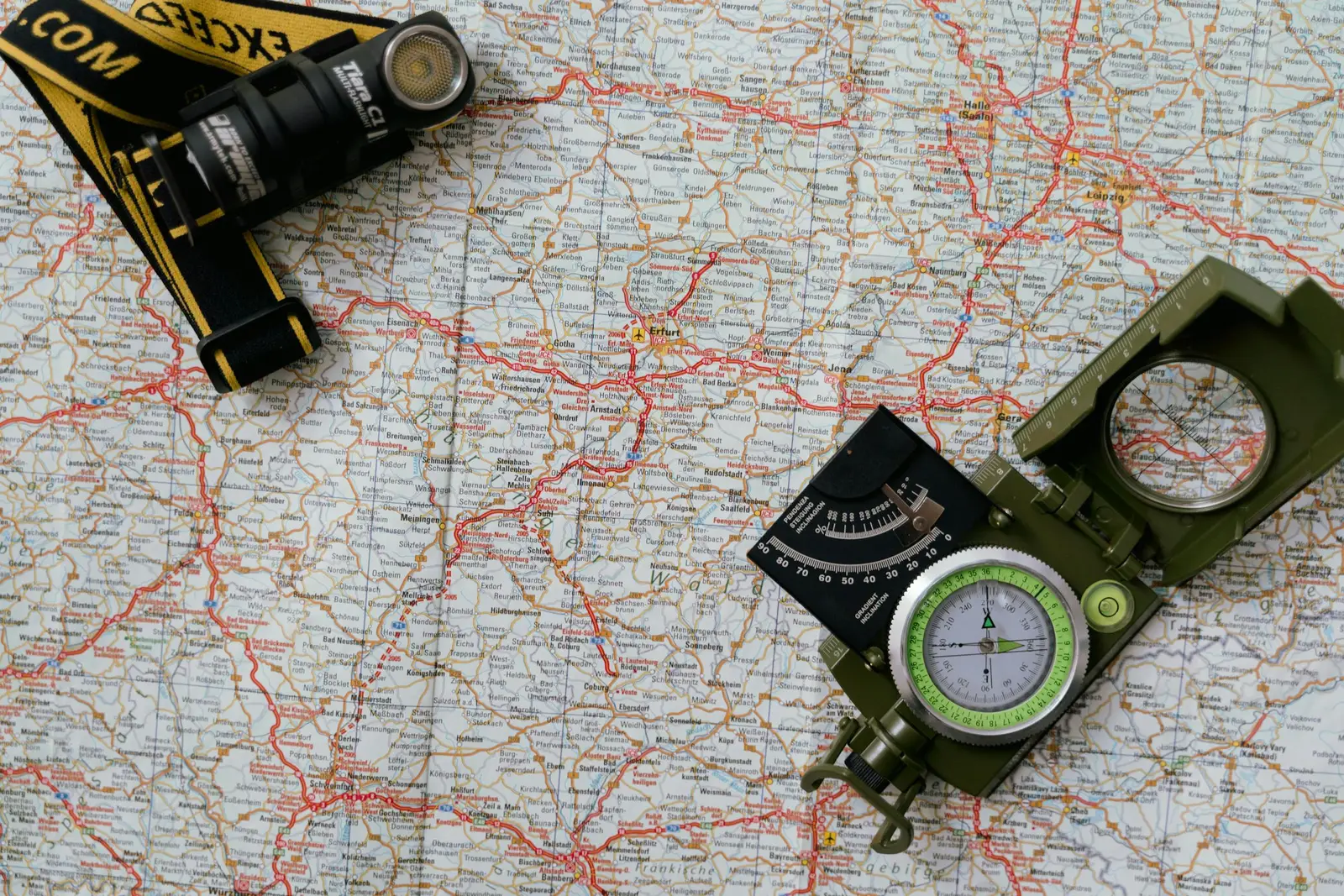 Surveyor with a GNSS rover over farmland with illustrative parcel-boundary overlay — illustrative photo